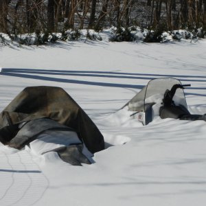 snowmobiles buried in snow
