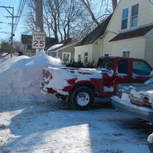 snow bank  after storm behind truck.